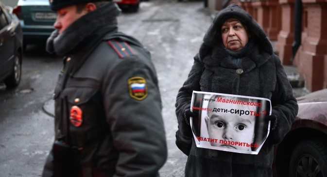 A participant in a picket against passing the law banning adoption of Russian children by American citizens, near the Russian State Duma. Source: RIA Novosti / Maxim Blinov