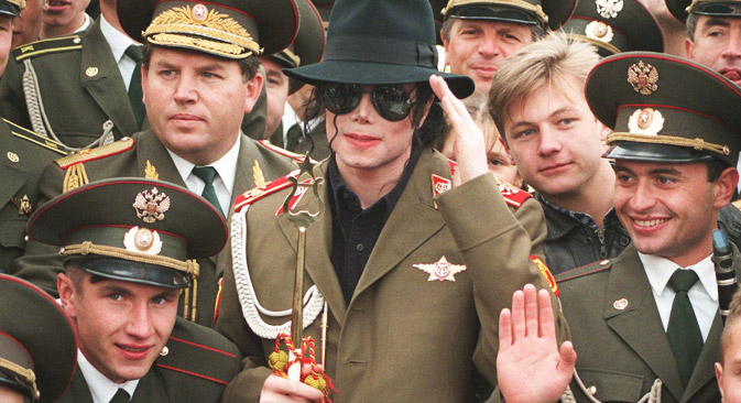American popstar Michael Jackson makes a mock military salute, as he is surrounded by Russian army musicians on Moscow's World War II memorial, Wednesday, Sept. 18, 1996. Jackson will leave Moscow Wednesday, after he performed a concert of his 'History" world tour Tuesday. Source: AP