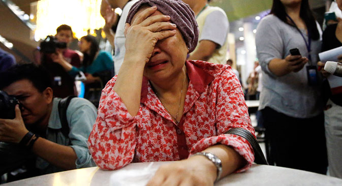 A woman cries at Kuala Lumpur International Airport as she waits for more information about the crashed plane, on July 18. Source: Reuters