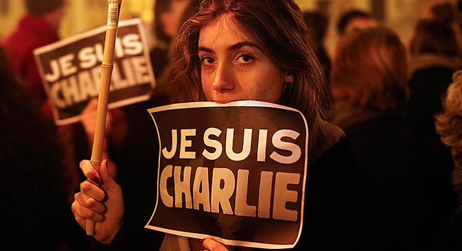 A woman holds a placard reading "I am Charlie" to pay tribute to the victims following a shooting by gunmen at the offices of weekly newspaper Charlie Hebdo in Paris in front of the French embassy in Rome January 8, 2015. Source: Reuters