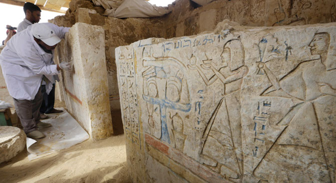 An Egyptian conservator cleans limestones at a newly-discovered tomb dating back to around 1100 B.C. at the Saqqara archaeological site, 19 miles south of Cairo, Egypt. Source: AP