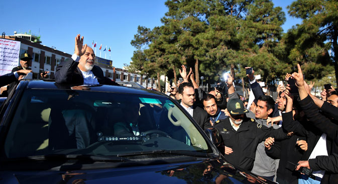 Iranian Foreign Minister Mohammad Javad Zarif, who is also Iran's top nuclear negotiator, waves to his well wishers upon arrival at the Mehrabad airport in Tehran, Iran, from Lausanne, Switzerland, Friday, April 3, 2015.  Source: AP
