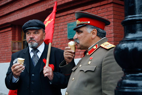 Vladimir Lenin(left) and Joseph Stalin look-a-likes eat ice cream as they share a minute of rest in downtown Moscow.