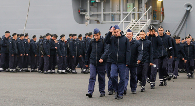 Russian sailors walk in front of the Mistral-class helicopter carrier Vladivostok at the STX Les Chantiers de l'Atlantique shipyard site in Saint-Nazaire, western France, November 25, 2014. Source: Reuters