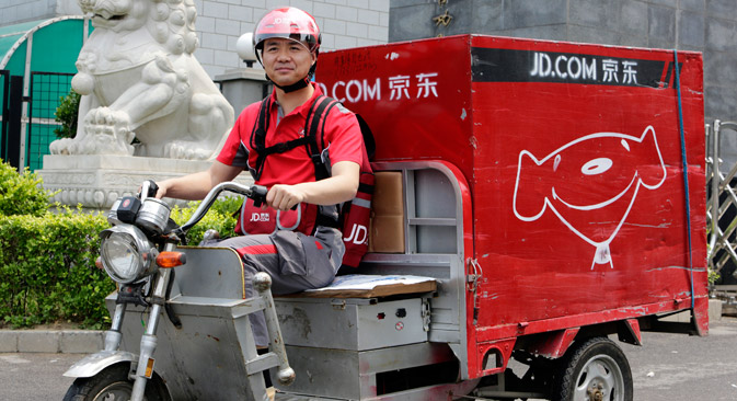 Richard Liu, CEO and founder of China's e-commerce company JD.com, rides an electric tricycle as he leaves a delivery station to deliver goods for customers to celebrate the anniversary of the founding of the company, in Beijing. Source: Reuters