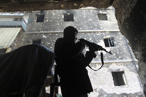 Miembro del Ejército Libre Sirio, opuesto a al Asad, toma posiciones en una casa en Alepo.