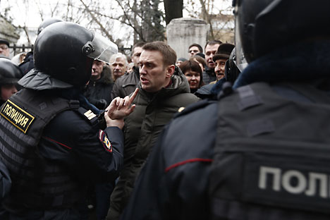 Pada musim panas 2013, Alexi Navalny (tengah), setelah memublikasikan investigasi antikorupsi secara online, didakwa dengan tuduhan penggelapan dan dijatuhi hukuman lima tahun penjara. Foto: Photoshot/Vostock Photo