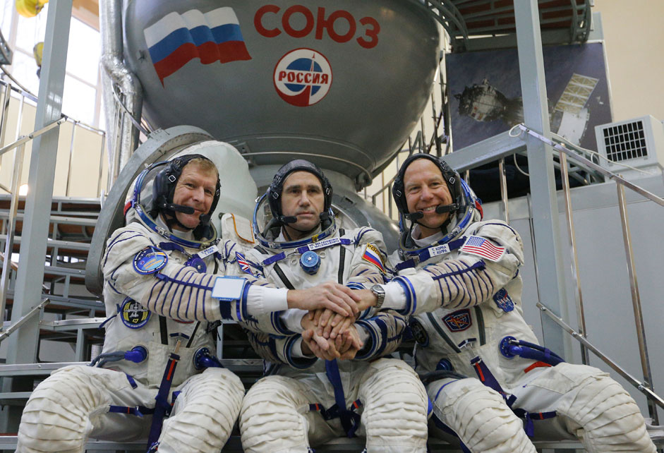 Members of the International Space Station expedition 46/47: (L-R) British ESA astronaut Timothy Peake, Russian cosmonaut Yuri Malenchenko and US NASA astronaut Timothy Kopra pose for the media in front of Soyuz space craft simulator prior to pass final exams in the Russian cosmonaut training center in Star City outside Moscow, Russia. Launch of the mission is scheduled on 15 December from cosmodrome Baikonur (Kazakhstan). 
