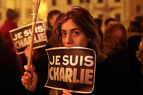 A woman holds a placard reading "I am Charlie" to pay tribute to the victims following a shooting by gunmen at the offices of weekly newspaper Charlie Hebdo in Paris in front of the French embassy in Rome January 8, 2015. Source: Reuters