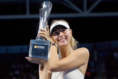 Maria Sharapova holds the Brisbane International tennis tournament women's singles trophy after defeating Ana Ivanovic of Serbia in Brisbane, January 10, 2015. Source: Reuters