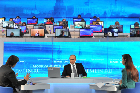 Vladimir Putin spent more than four hours answering questions from the public on various issues in the annual broadcast. Source: EPA