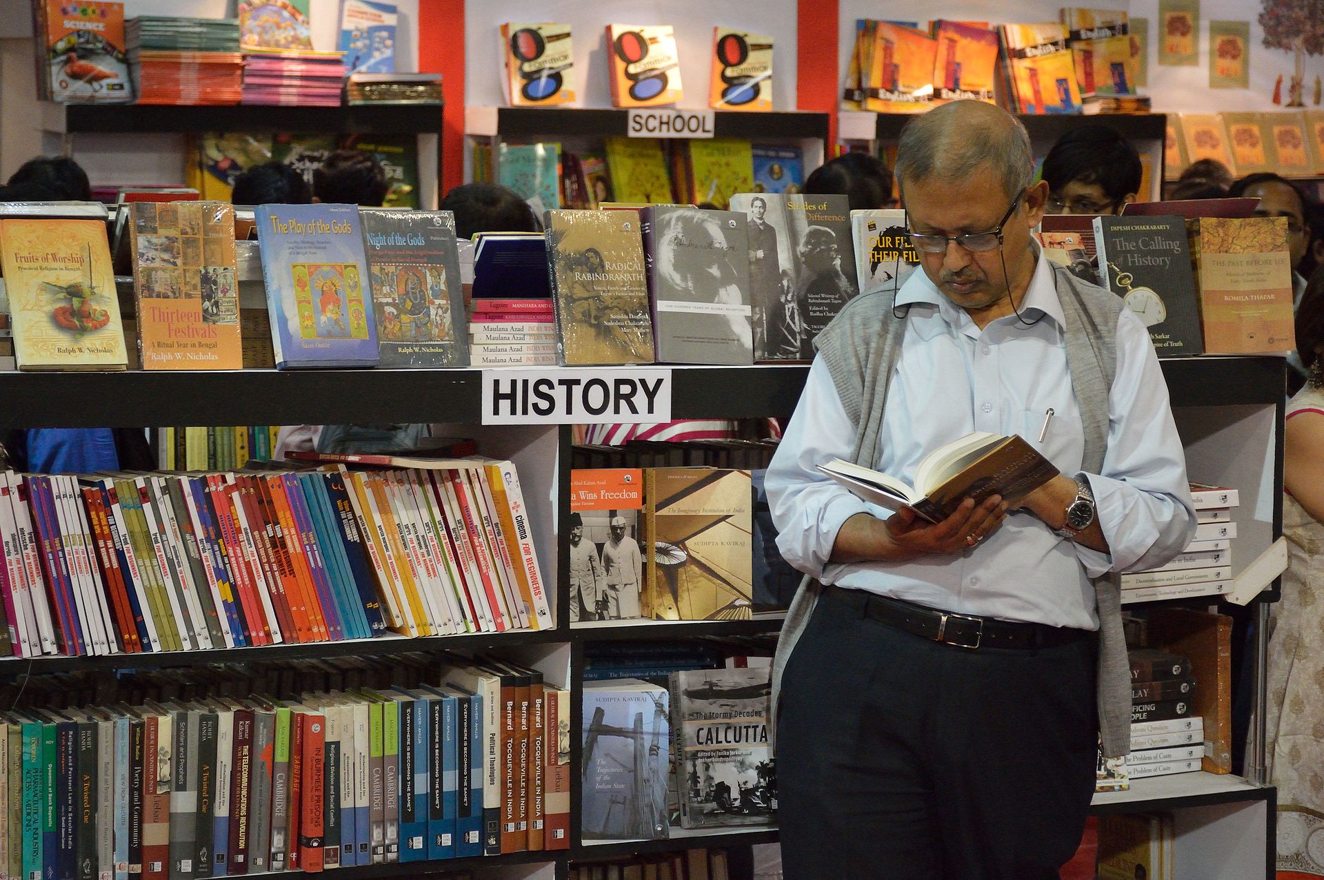 A reader browses through history books at the 2016 Kolkata International Book Fair.