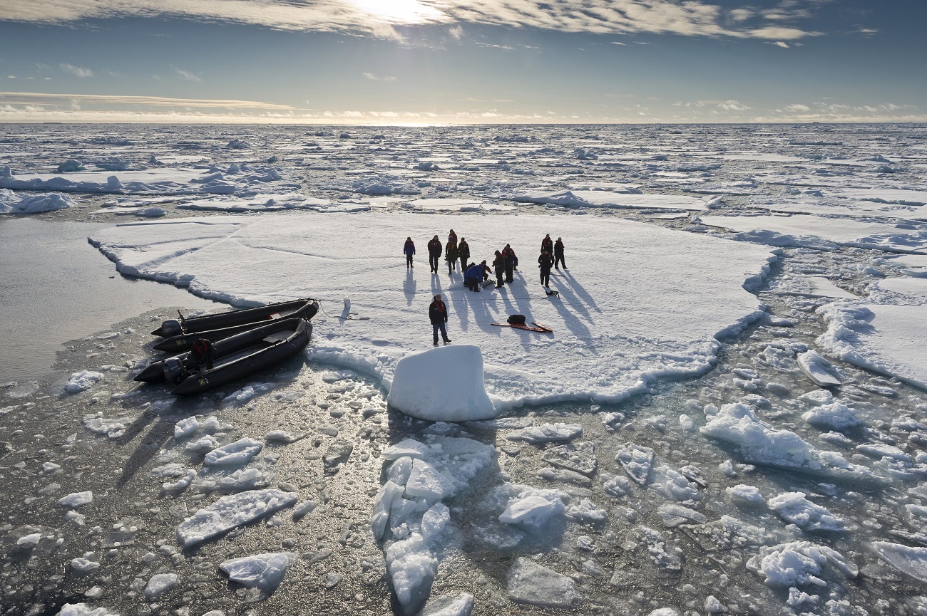Tourists taken in inflatable boats onto an ice floe, pack ice, Spitsbergen Island, Svalbard Archipelago.