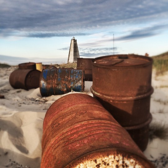 Rusty barrels in the sand