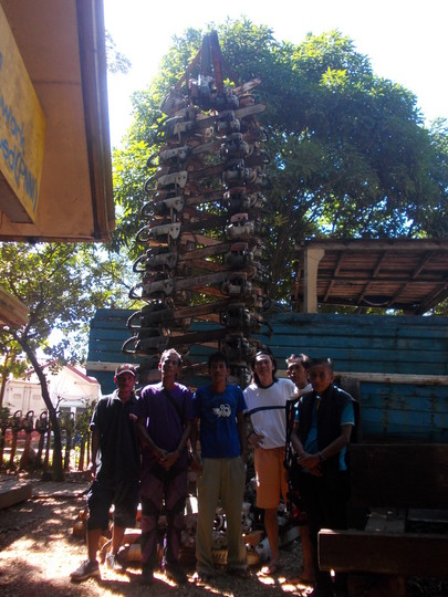 Ecological activists of Palawan Island stand in front of tower made of confiscated chainsaws
